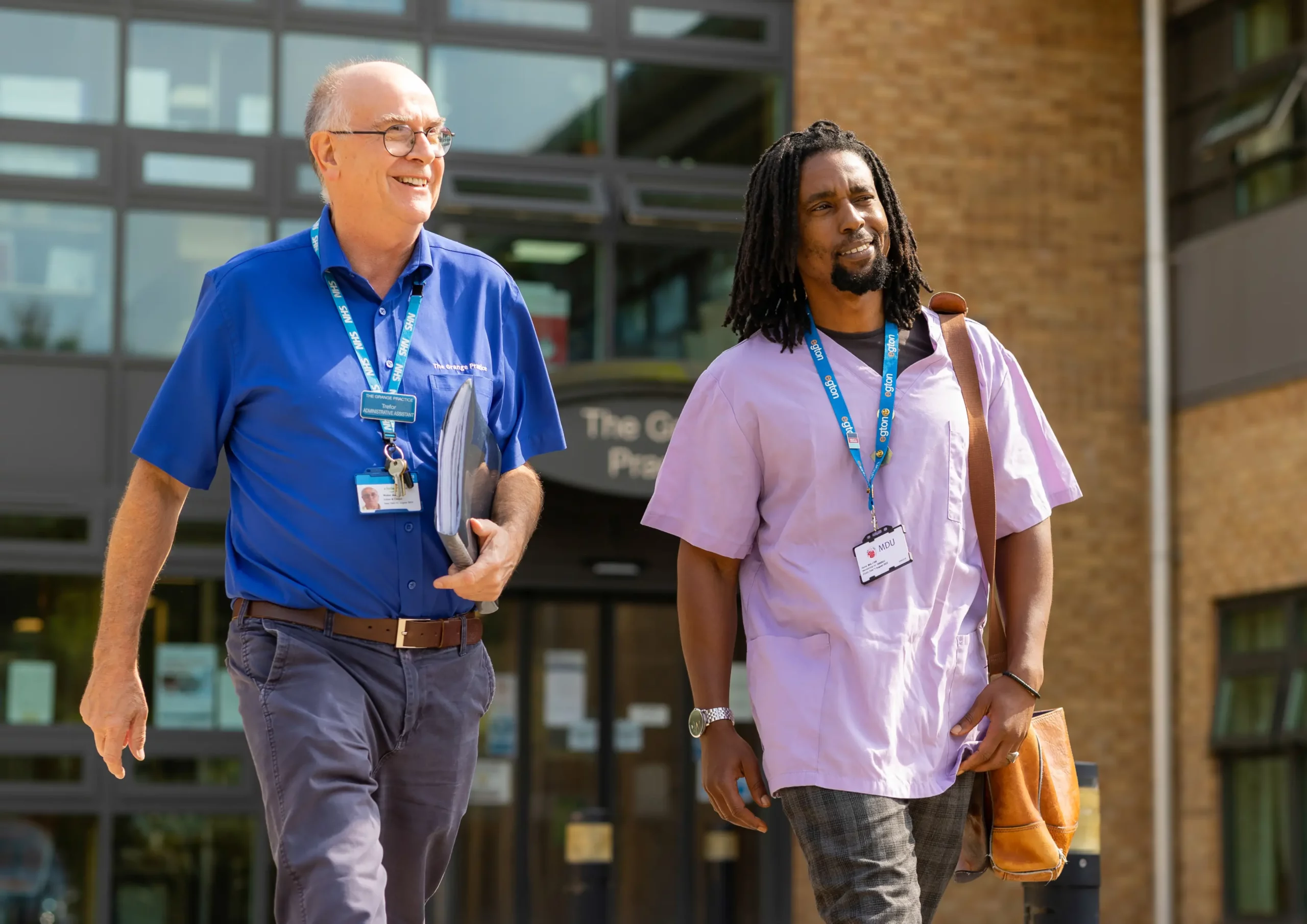 NHS Kent & Medway - An older man and a young man walking and smiling