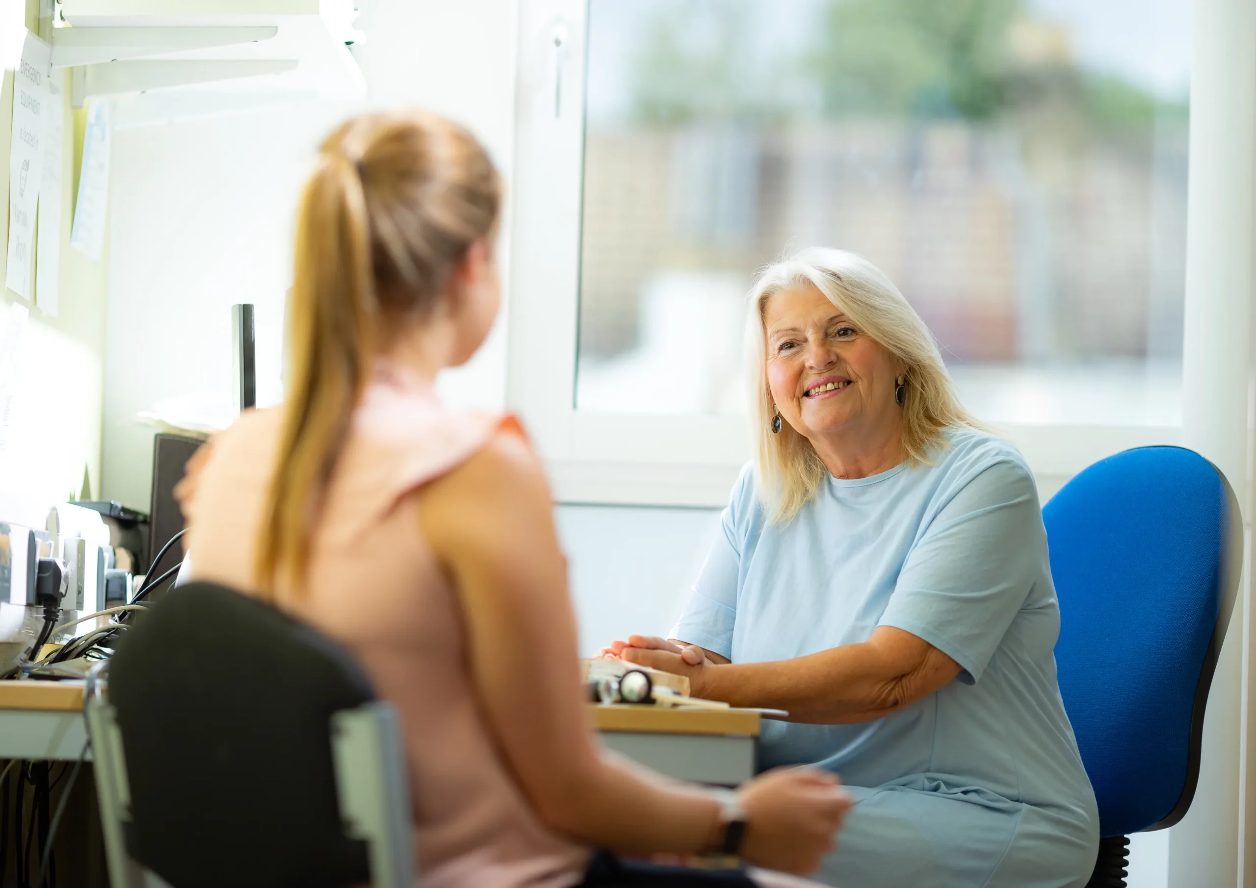 NHS Kent & Medway - An older women smiling at a younger woman